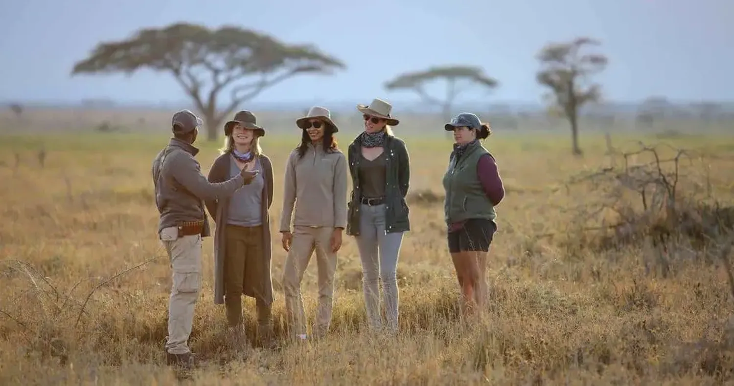 Qualified Tanzania safari driver-guide beside a 4x4 during a six-day Northern Circuit safari