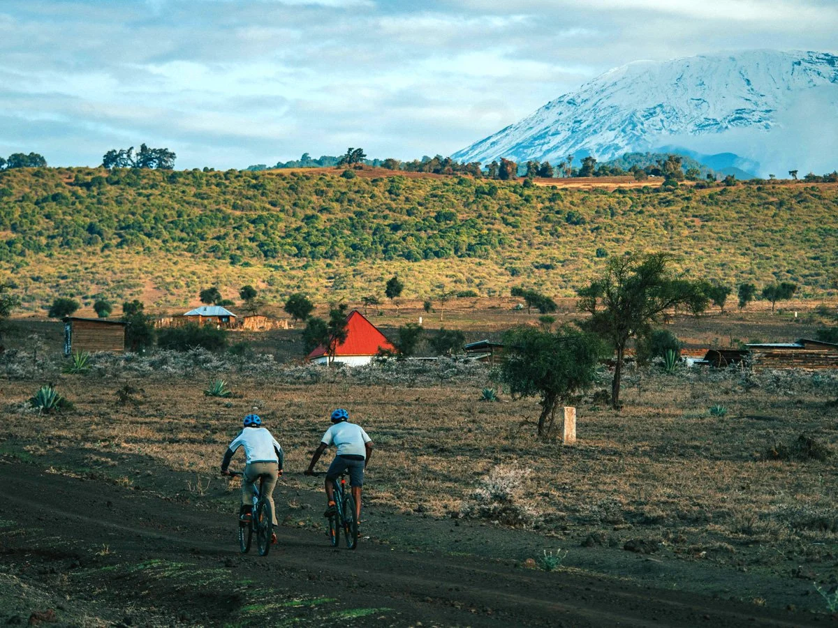 Cyclists riding from Kilimanjaro foothills toward Ngorongoro highlands