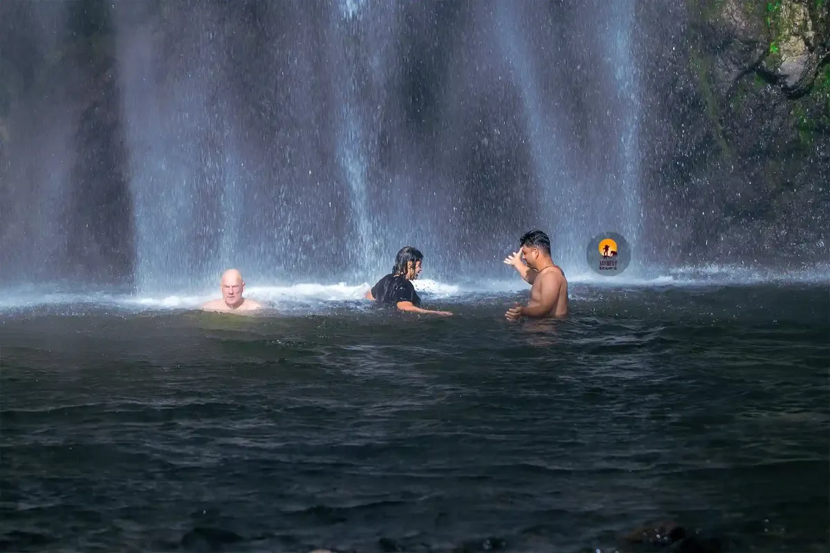 People swimming in the pool below the Materuni waterfall on the slopes of Kilimanjaro